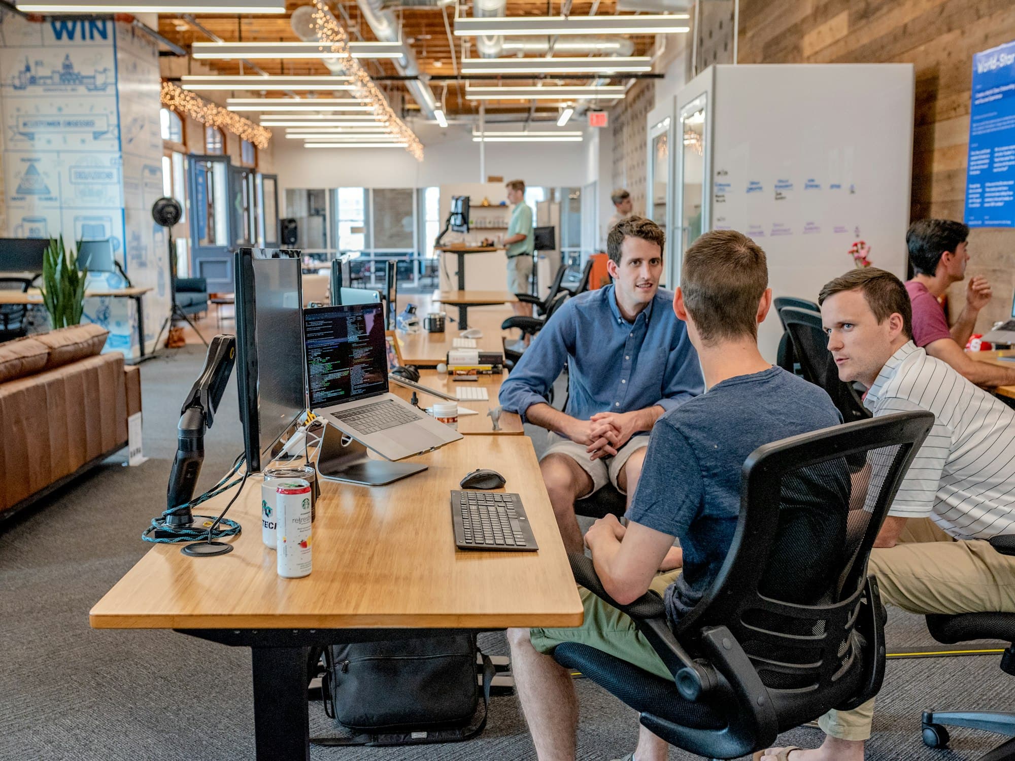 A small team working at laptops in a shared office